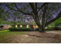 Charming brick home with a mature tree, manicured lawn and inviting curb appeal at 943 Mikell Dr, Charleston, SC 29412