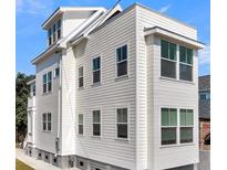 Charming home showcasing light-colored siding and contrasting trim under a bright blue sky at 101 Hanover St, Charleston, SC 29403