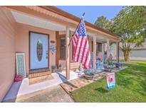Charming home featuring an inviting front porch with patriotic decor and curb appeal at 106 Nottingham Ct, Summerville, SC 29485