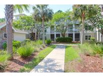 Charming condo community featuring lush landscaping, palm trees, and well-maintained walkways at 1300 Park West Blvd # 512, Mount Pleasant, SC 29466