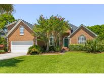 Charming brick home with lush green lawn, mature trees, and a welcoming front entrance at 1441 Waterside Ct, Mount Pleasant, SC 29464