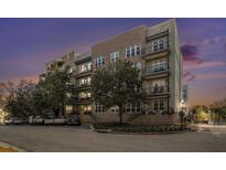 Stunning exterior view of a brick apartment building with multiple balconies at dusk at 145 Pier View St # 111, Charleston, SC 29492