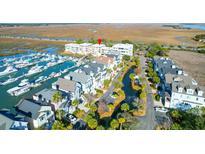 Stunning aerial view of waterfront condos and a marina with many boats in a coastal community at 1608 Marsh Harbor Ln # C, Mount Pleasant, SC 29464