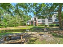 Apartment building overlooking a pond with picnic tables and grill for outdoor enjoyment at 2011 N Highway 17 # 1400P, Mount Pleasant, SC 29466