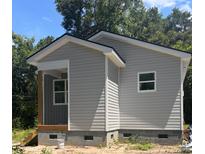 Charming single-story home featuring gray siding, a covered porch, and a neatly maintained foundation at 2635 Tillman St, North Charleston, SC 29405