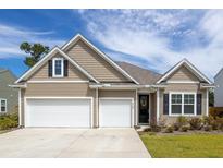 Charming home featuring a two-car garage, neutral siding, and a well-manicured front yard at 2722 Sunrose Ln, Johns Island, SC 29455