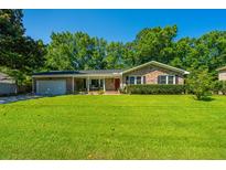 Charming brick home featuring a manicured lawn, inviting entrance, and attached garage at 2847 Limestone Blvd, Charleston, SC 29414