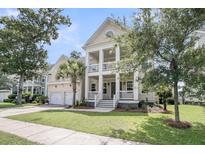 Charming two-story home featuring a spacious front yard and double front porches for enjoying the outdoors at 3020 River Vista Way, Mount Pleasant, SC 29466