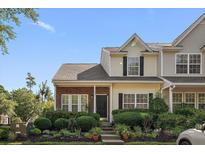 Charming townhome featuring a manicured lawn and inviting front porch at 312 Kelsey Blvd, Wando, SC 29492