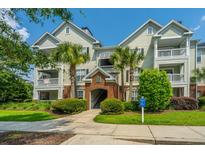 Inviting condo complex with manicured landscaping and covered walkways, offering a relaxed residential atmosphere at 45 Scyamore Ave # 623, Charleston, SC 29407