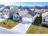 Charming single-Gathering home with a well-manicured lawn and a two-car garage at 5000 Paddy Field Way, Ladson, SC 29456