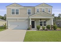 Two story home featuring manicured lawn, two car garage, craftsman architecture, and a welcoming front porch at 505 Spanish Wells Road Rd, Summerville, SC 29486