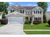 Charming two-story home with a manicured lawn, attached garage, and beautiful landscaping in a suburban neighborhood at 644 Grassy Hill Rd, Summerville, SC 29483