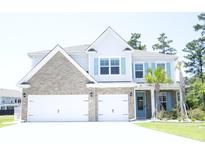 Charming two-story home featuring a brick and siding facade, a three-car garage, and lush landscaping at 103 Granton Edge Ln, Summerville, SC 29486