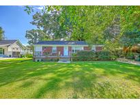 Charming brick home with a well-manicured lawn and inviting front porch, perfect for enjoying the outdoors at 131 Harvey Ave, Goose Creek, SC 29445
