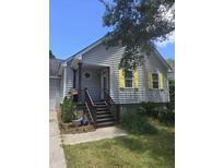 Charming single-Gathering home features light gray siding, yellow shutters, and a cozy front porch at 1346 Ellison Run, Charleston, SC 29412