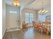 Inviting dining room with wood floors, chandelier, and front door access, perfect for gatherings at 139 Back Tee Cir, Summerville, SC 29485