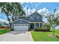 Charming two-story home featuring a well-manicured lawn and a two car garage at 2024 Lanneau Ln, Johns Island, SC 29455