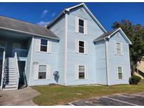 Charming light blue two-story condo featuring white trim and multi-pane windows under a clear blue sky at 2030 Coldspring Dr # 707 G, North Charleston, SC 29406