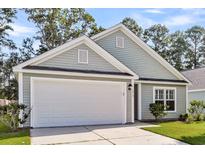 Charming home featuring a two-car garage, neutral siding, and well-maintained landscaping at 210 Wildberry Ln, Goose Creek, SC 29445