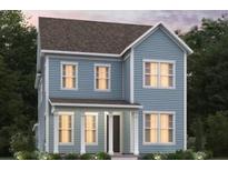 Charming two-story blue home with a covered porch and white pillars, surrounded by lush greenery and trees at 359 Trailmore Ln, Summerville, SC 29486