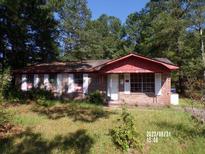 Exterior view of a single story home with brick and red accents at 403 Bryan St, Summerville, SC 29483