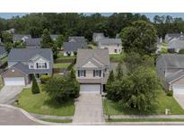 Two-story home with manicured lawn, driveway, and mature trees in a residential neighborhood at 406 Brookfield Ln, Goose Creek, SC 29445