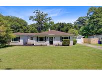 Charming single-story home with a lush green lawn and traditional architectural details at 422 Geddes Ave, Charleston, SC 29407