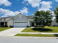Charming single-story home featuring a well-manicured lawn, attached two-car garage, and inviting front entryway at 699 Battery Edge Dr, Summerville, SC 29486