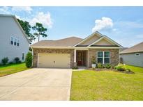 Charming brick home featuring a manicured lawn, two-car garage, and inviting front porch at 1250 Hammrick Ln, Johns Island, SC 29455