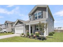 Charming two-story home with a landscaped front yard and an attached garage in a suburban neighborhood at 134 Ivory Shadow Rd, Summerville, SC 29486