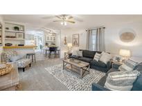 Cozy living room with plush seating, stylish decor, and an open layout to the dining area at 1617 Refuge Run, Charleston, SC 29412