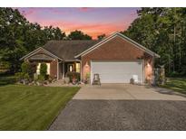 Charming brick home featuring a two-car garage, well-manicured landscaping, and inviting curb appeal at 214 Deer Ridge Court Ct, Huger, SC 29450