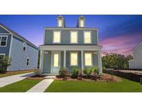 Charming two-story home with a covered front porch and manicured lawn at 222 Terrace View Dr, Summerville, SC 29486