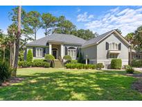 Charming single-Gathering home boasts professionally landscaped front yard, covered entryway, and neutral colors at 2340 Marsh Hen Dr, Seabrook Island, SC 29455
