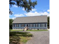 Charming one-story home with blue siding, black shutters, and a gravel driveway at 2460 Bama Rd, Cottageville, SC 29435