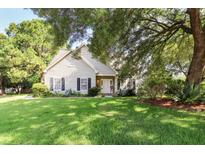 Charming single-Gathering home with a lush green lawn and mature trees providing shade at 339 Mount Royall Dr, Mount Pleasant, SC 29464