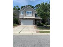 Charming two-story home with a stone-accented facade, attached two-car garage, and well-maintained front yard at 3808 Tupelo Branch Row, Mount Pleasant, SC 29429