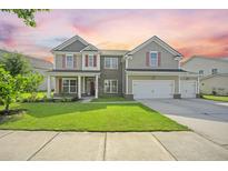 Charming two-story home featuring a manicured lawn and inviting curb appeal at 438 Flat Rock Ln, Summerville, SC 29486