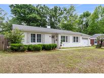 Charming one story home featuring a well manicured lawn, shuttered windows and brick exterior at 5028 Victoria Ave, North Charleston, SC 29405
