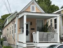Charming home featuring a covered front porch with white railing and neutral exterior paint at 7 Dingle St, Charleston, SC 29403