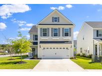 Charming two-story home with a white garage door and beautiful landscaping at 101 Guernsey Ln, Summerville, SC 29483
