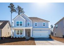 Charming two-story home with blue siding, white trim, and a two-car garage at 1029 Riverbed Retreat Ln, Summerville, SC 29485