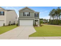 Charming two-story home with a well-manicured lawn and a two-car garage on a beautiful sunny day at 1035 Forrest Creek Dr, Summerville, SC 29483