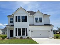 Charming two-story home with a white exterior, black shutters, and a well-manicured lawn at 110 Captains Creek Ln, Ridgeville, SC 29472