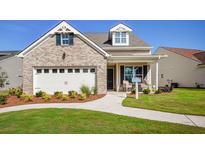 Charming single-Gathering home featuring a brick facade, well-manicured lawn, and attached two-car garage at 114 Magnolia House Dr, Summerville, SC 29486