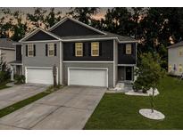 Two-story townhome features a two-car garage and landscaped front yard at 116 Bright Meadow Rd, Summerville, SC 29483