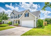 Charming two-story home featuring a well-maintained lawn, two-car garage and classic architectural details at 170 Highwoods Plantation Ave, Summerville, SC 29485