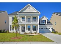 Charming two-story home with a well-manicured lawn and a two-car garage at 1816 Nola Run, Summerville, SC 29485