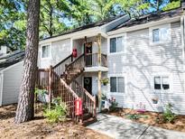 Charming condo with a gray exterior, wood stairs and inviting decor at 19 Rudwick Cir, Goose Creek, SC 29445